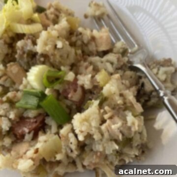 A scoop of jambalaya on a plate with a fork.