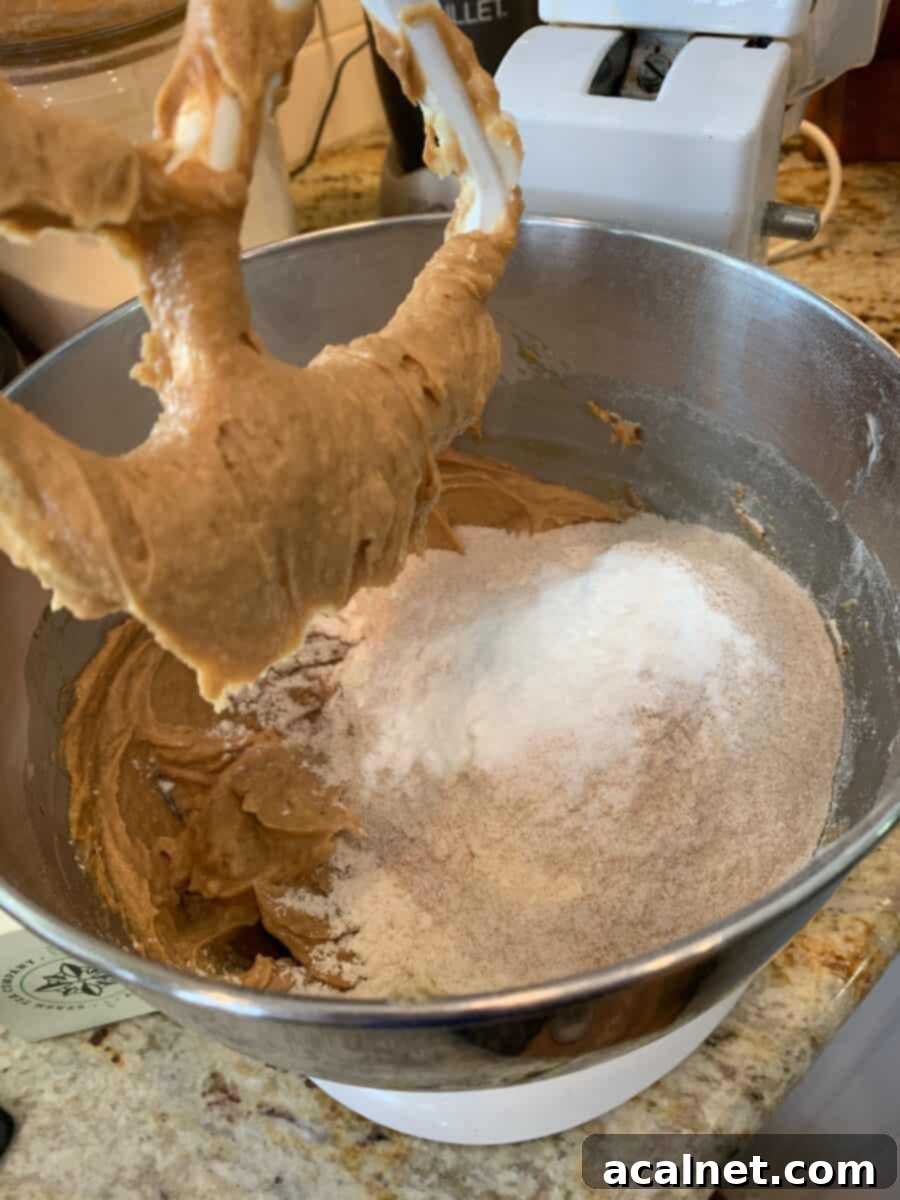 Grandma's Chewy Peanut Butter Cookies 4 Wet ingredients for peanut butter cookies being creamed together in a stand mixer, demonstrating the first step.