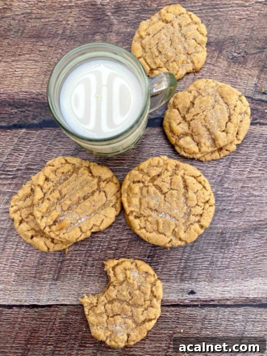Grandma's Chewy Peanut Butter Cookies 9 Six beautifully arranged old-fashioned peanut butter cookies on a rustic wooden board, with a glass of milk, highlighting their classic appeal.
