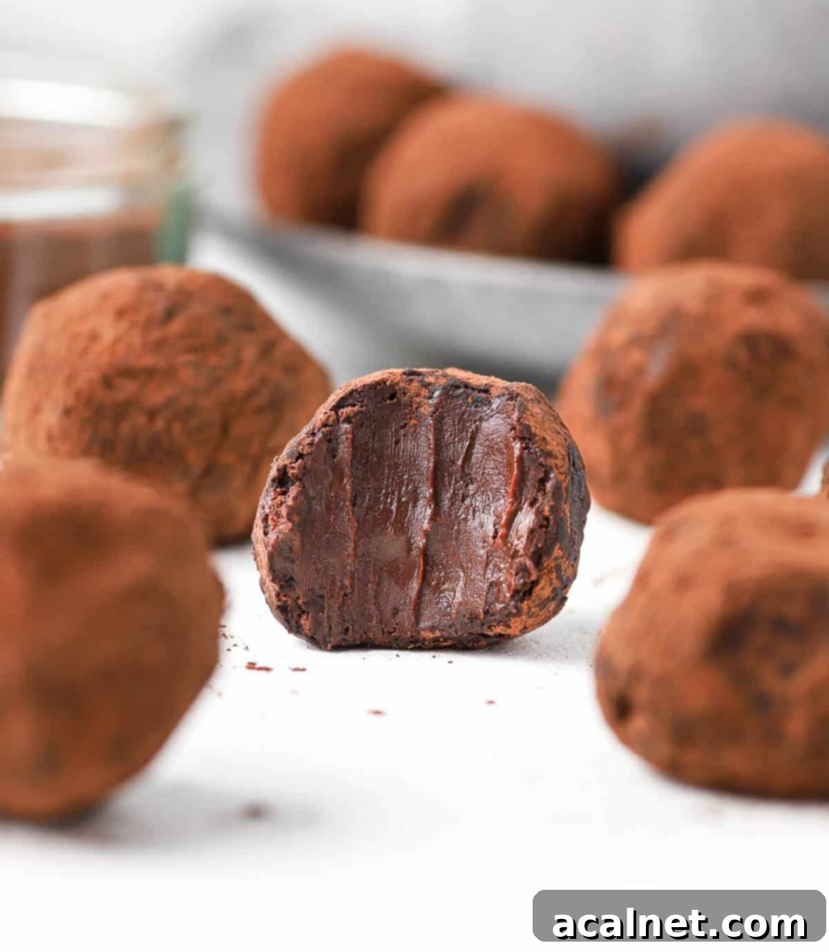 Close up on one truffle with a bite taken off.