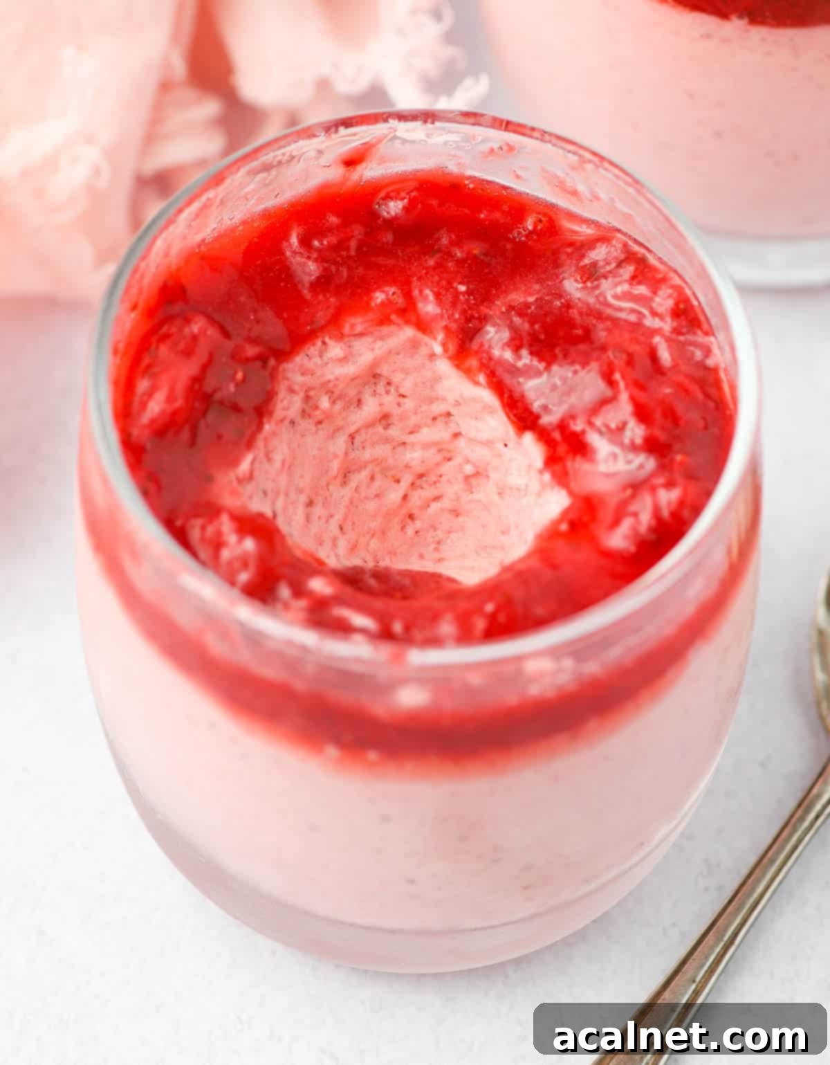 Quick and Creamy Strawberry Mousse 8 A spoon of mousse taken out of the glass.