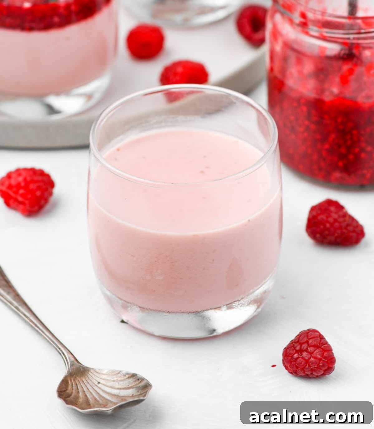 Effortless Raspberry Panna Cotta 7 Raspberry cream set in a glass cup, ready to be topped.