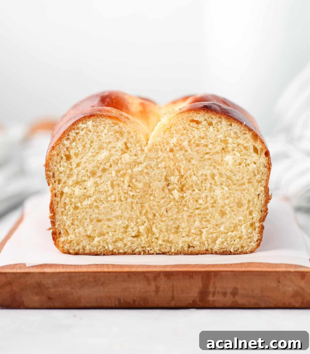 A close-up view of the interior crumb of a sliced brioche loaf, highlighting its airy, tender texture.