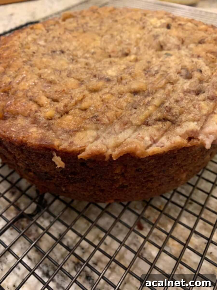 A round loaf of banana bread on a cooling rack.