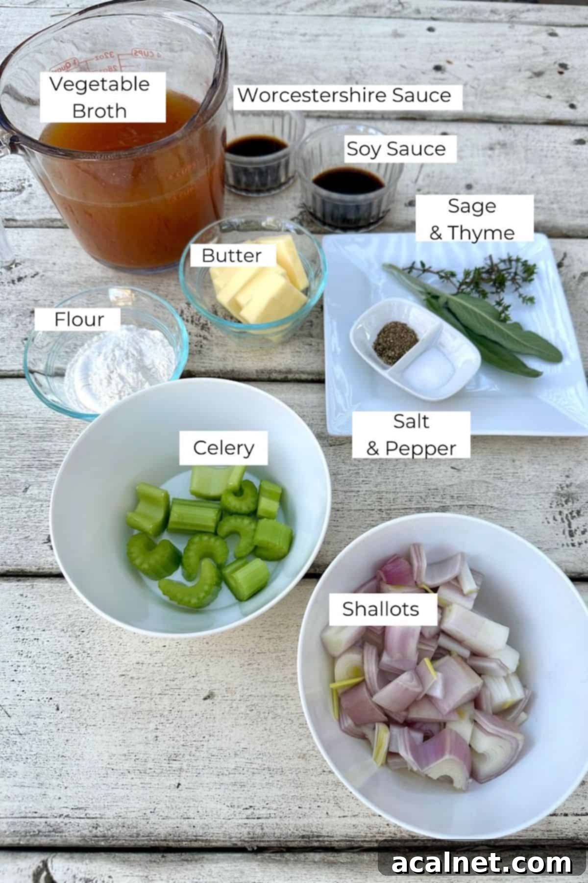 Ingredients for Make Ahead Gravy laid out in small bowls on a wooden table, with clear labels.