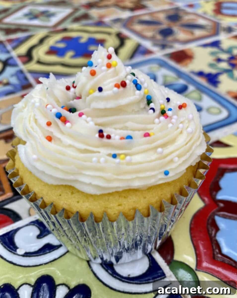 Frosted cupcake on a table.