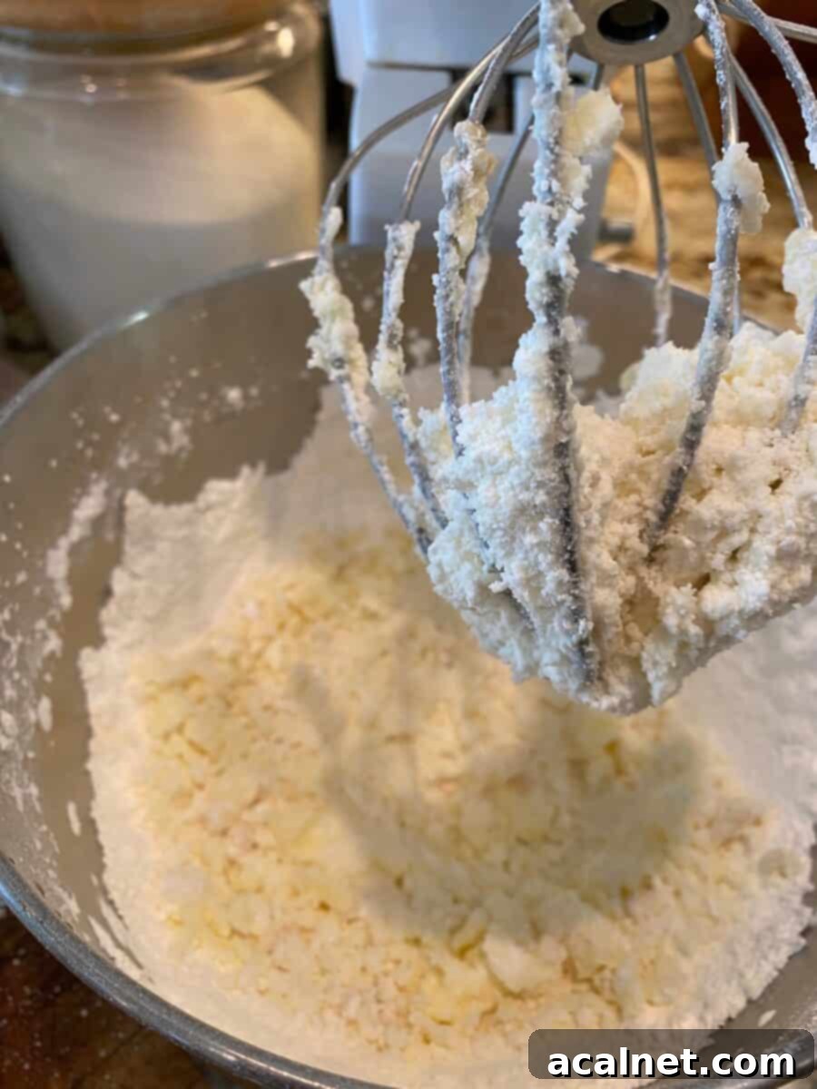 A mixing bowl and beaters with powdered sugar and butter, whipped together. 