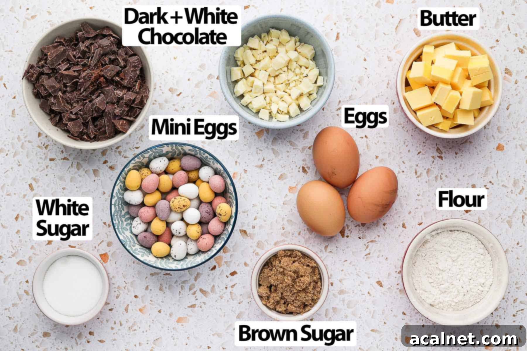 Ingredients for Mini Egg Brownies laid out on a white and pink surface.