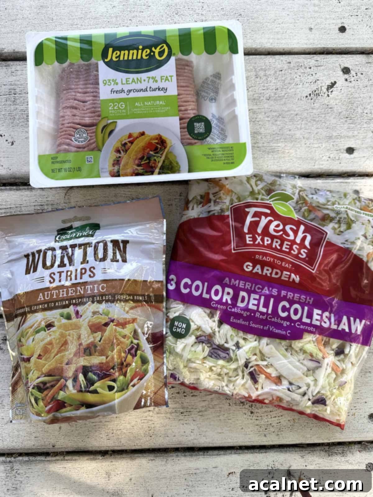 Sealed packages of ground turkey, wonton strips, and coleslaw mix, showing the convenience of pre-packaged ingredients.