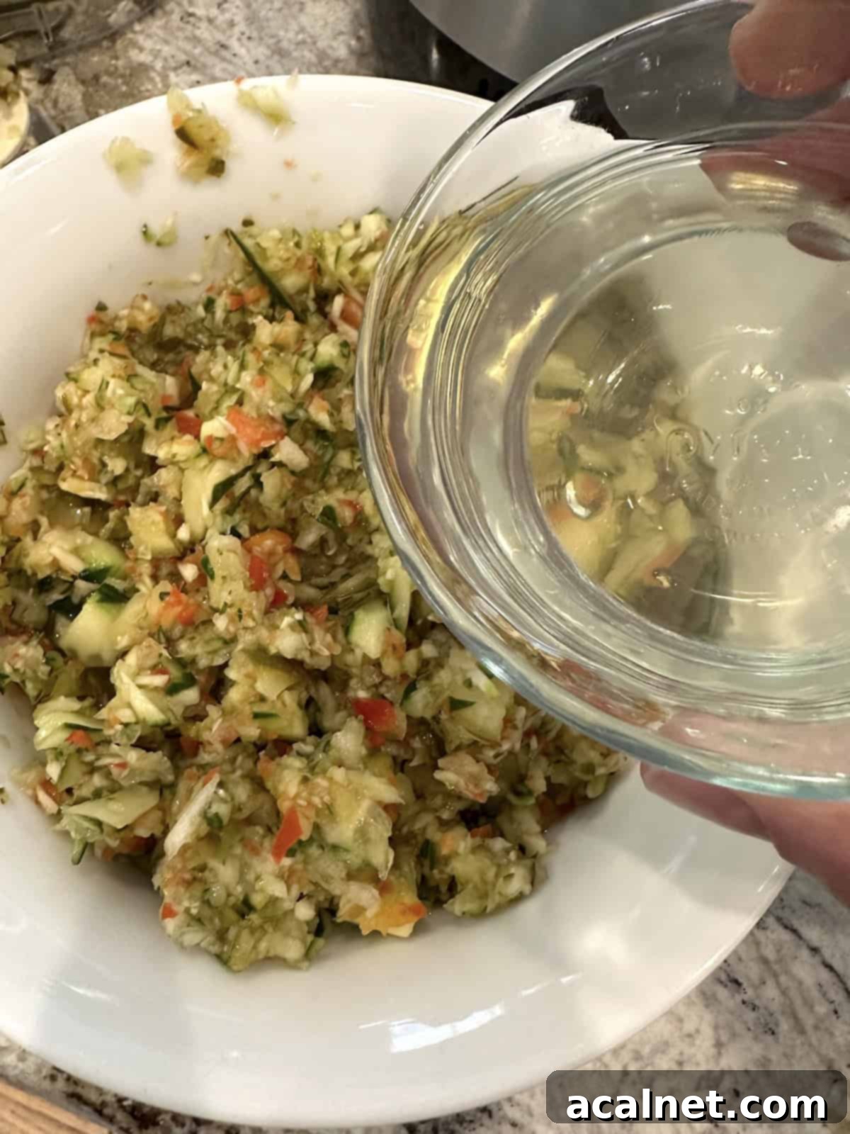 Pickle de gallo ingredients in a bowl with a small bowl of vinegar, ready to be combined.