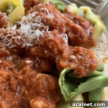 Tomato-cream sauce on top of plain and spinach tortellini.