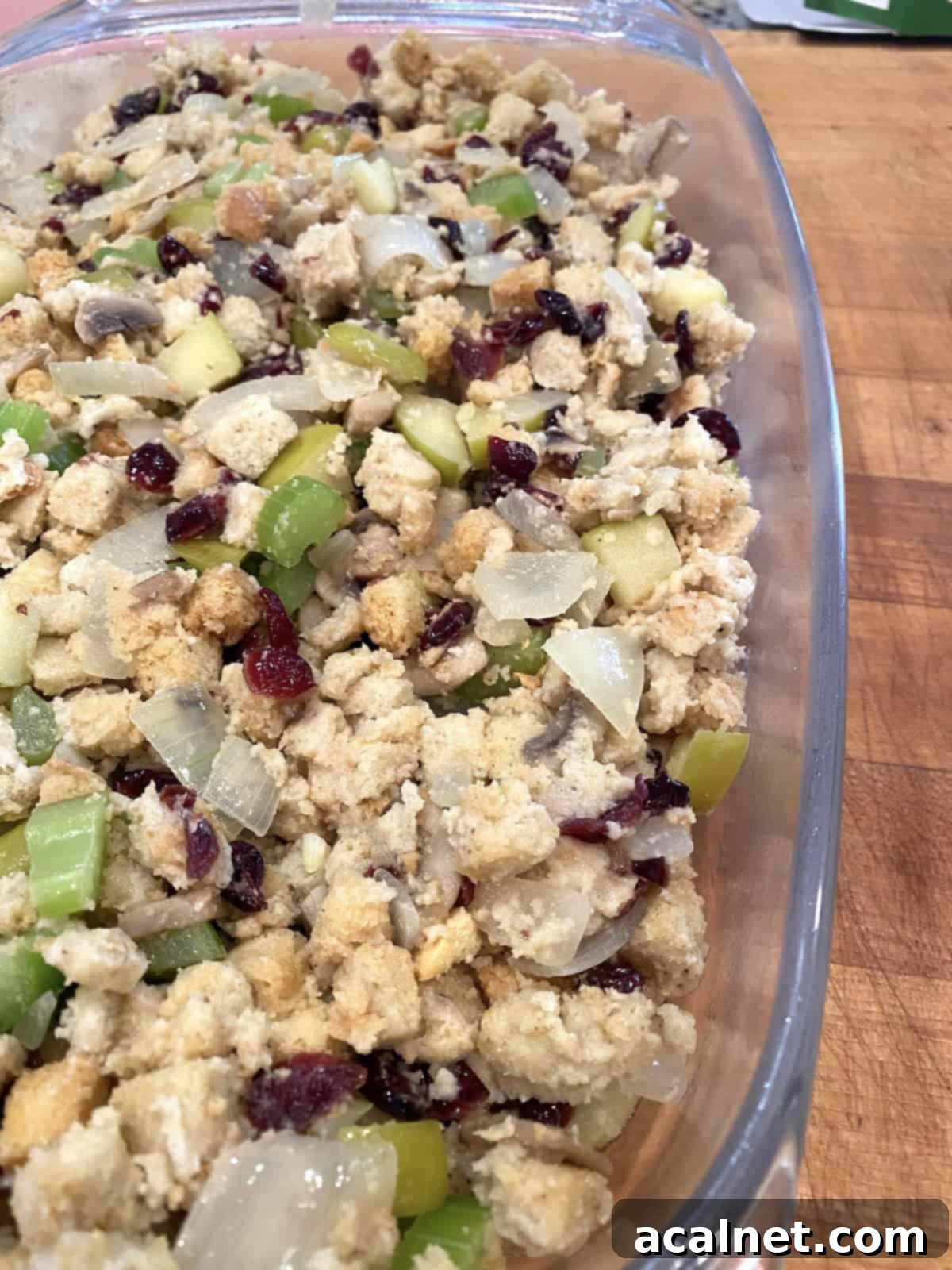 Sweet and Savory Cranberry Apple Stuffing 12 A casserole dish filled with the prepared stuffing and vegetables, ready for baking.