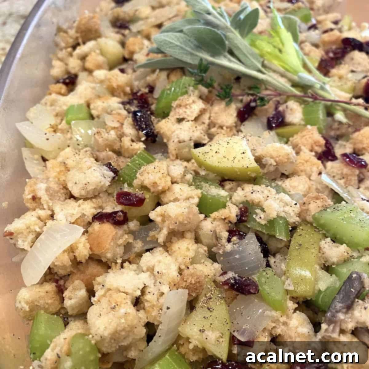 Sweet and Savory Cranberry Apple Stuffing 13 A serving dish of Cranberry Apple Stuffing, showing the mix of apples, craisins, and celery.
