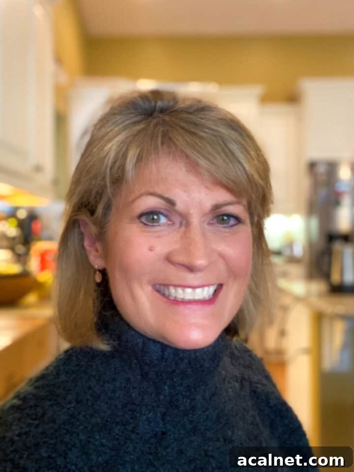 Sweet and Savory Cranberry Apple Stuffing 3 Melinda Keckler smiling in her kitchen.