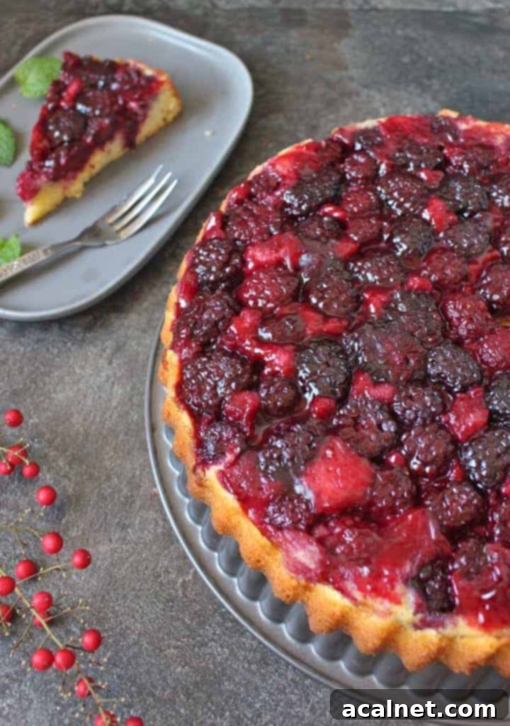 Half of the cake on the baking pan with a slice on a grey plate