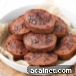 Decadent Chocolate Financiers 8 Close up on a stack of financiers cakes in a large white bowl.