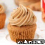 Frosting piped on a cupcake placed in a small white plate.