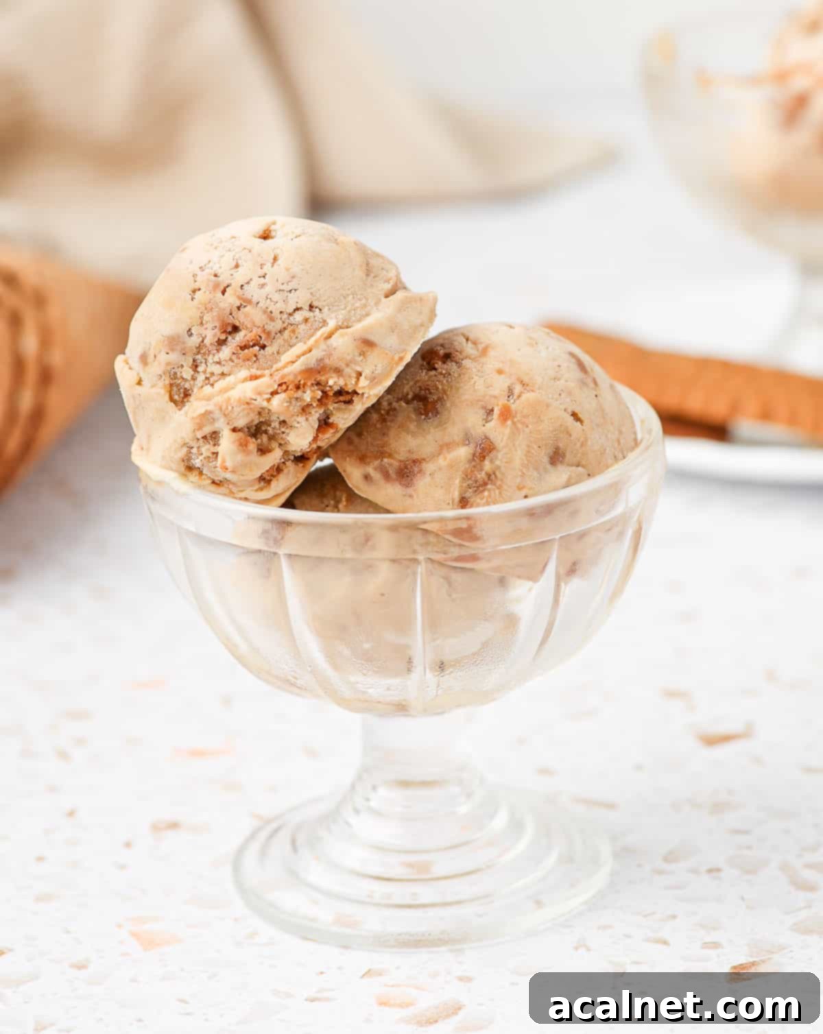 Scoops of ice cream in a glass serving cup.