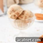 Close up on 3 scoops of ice cream in a glass dessert cup.