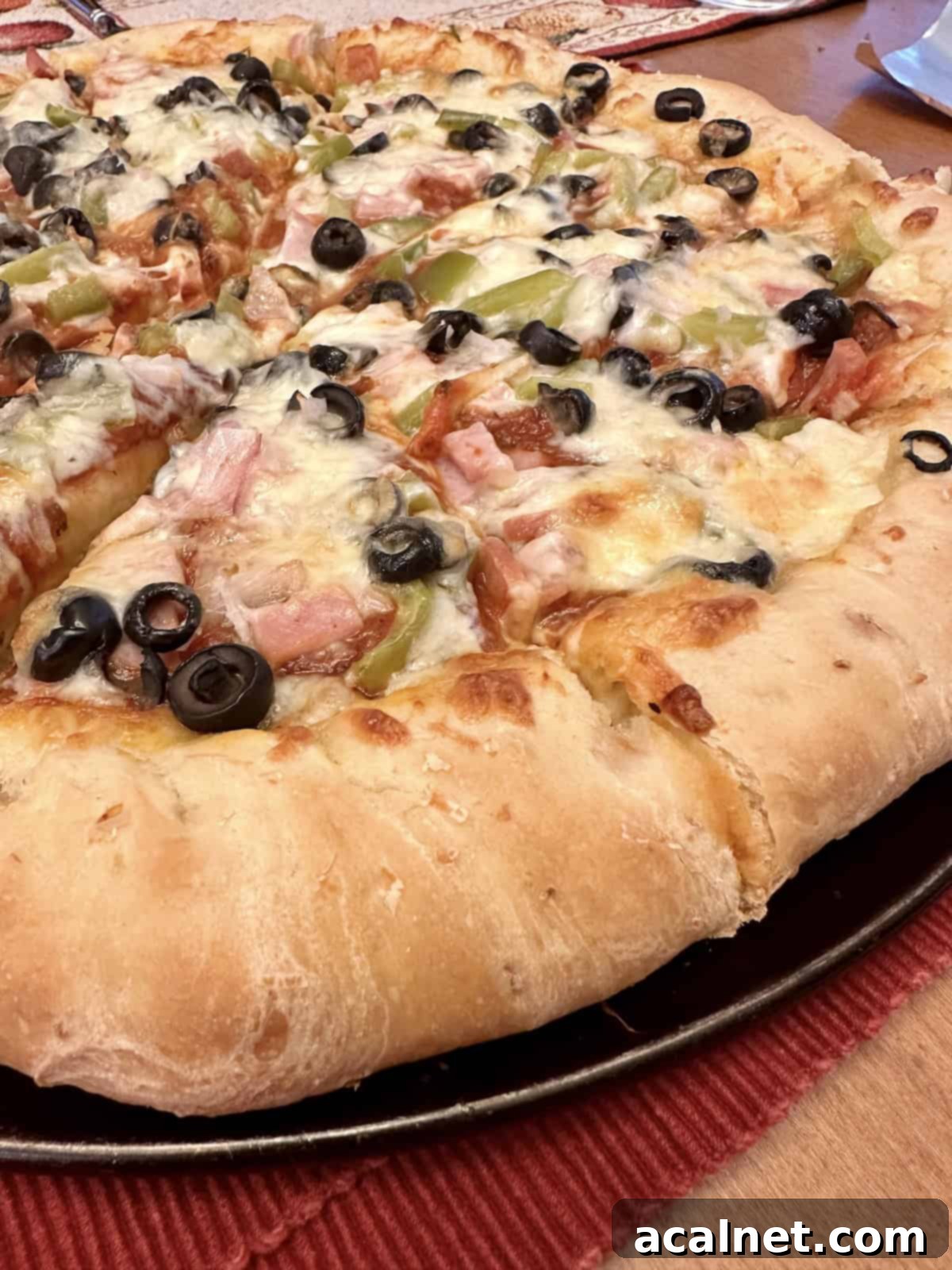 A baked pizza on a pizza pan.