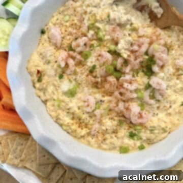 Irresistible Crab and Shrimp Dip 14 Shrimp and crab dip on a serving platter with crackers and vegetables, highlighting its delicious appeal.