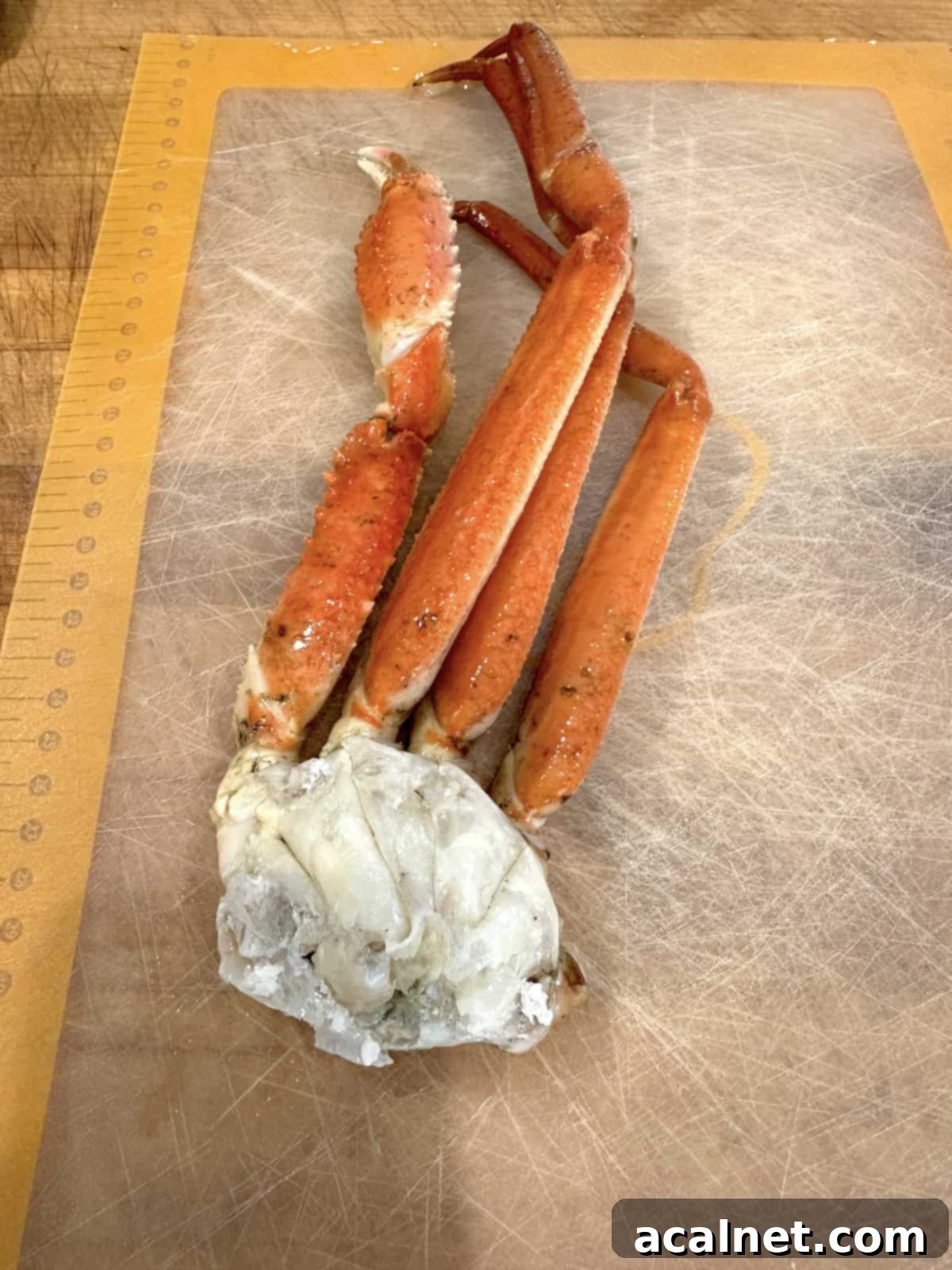 Irresistible Crab and Shrimp Dip 5 Two cooked crab legs resting on a cutting board, ready for meat extraction.