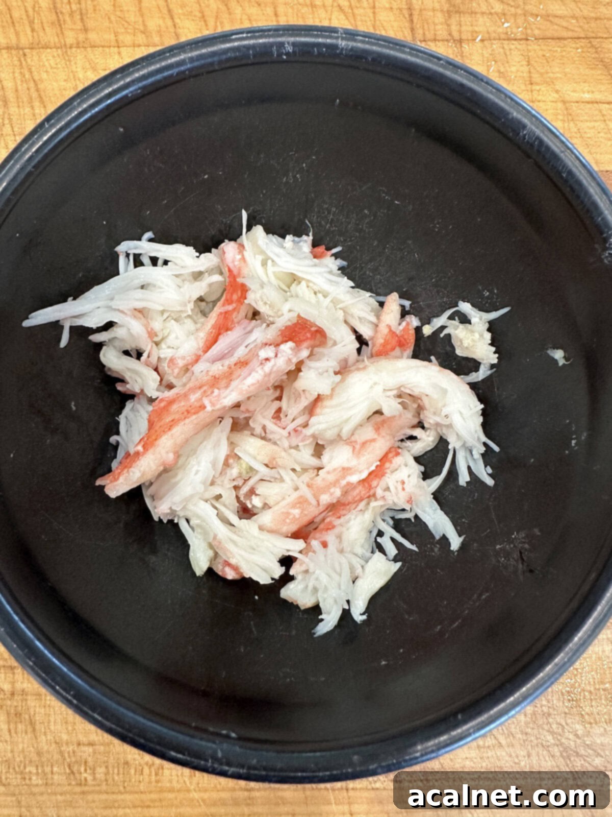 Irresistible Crab and Shrimp Dip 6 A bowl filled with freshly extracted, flaky white crabmeat, ready for use in a recipe.