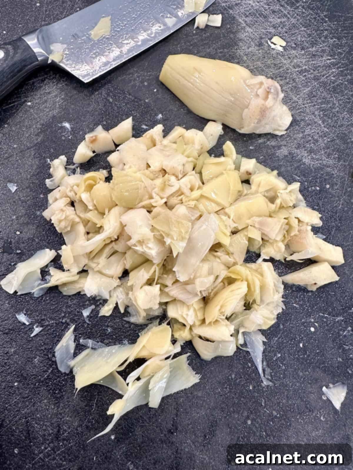 Irresistible Crab and Shrimp Dip 7 Diced artichoke hearts on a cutting board, ready for the dip mixture.