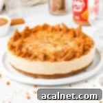 Effortless Biscoff Cheesecake Bliss 10 Biscoff Cheesecake topped with chunks of biscoff cookies on a white plate over a white surface,