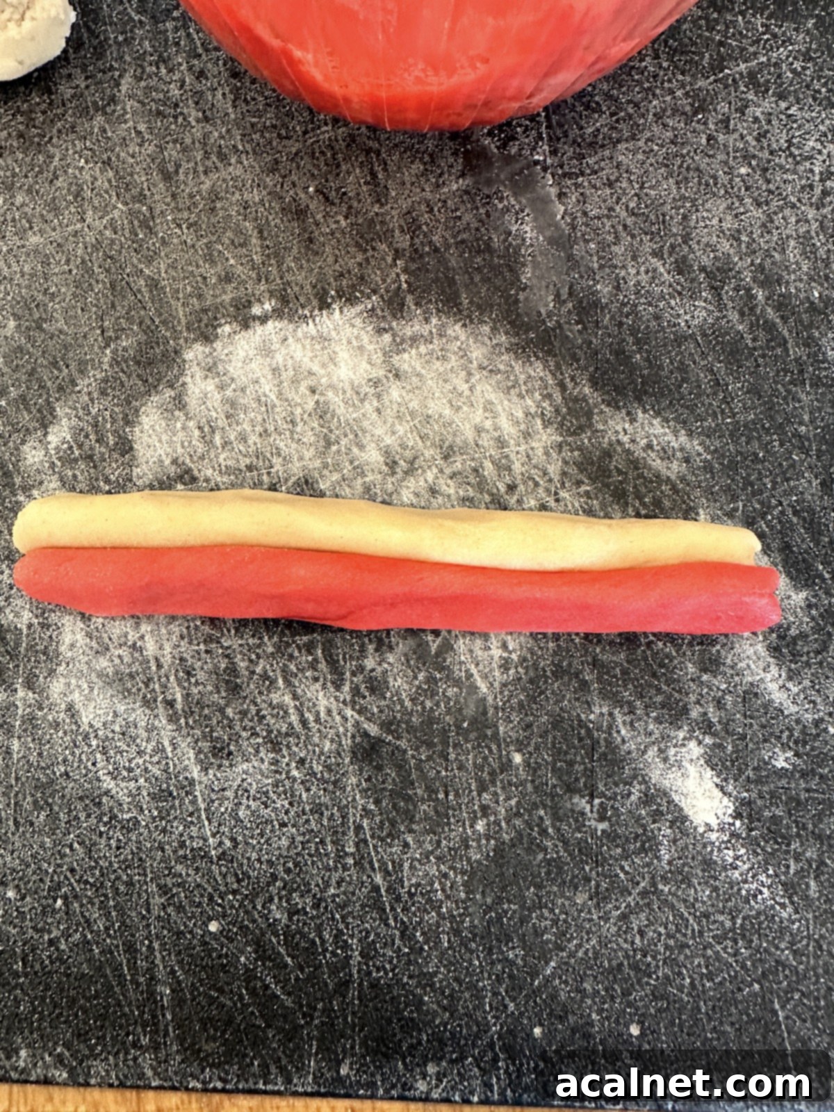Christmas candy cane cookie strips on a cutting board.