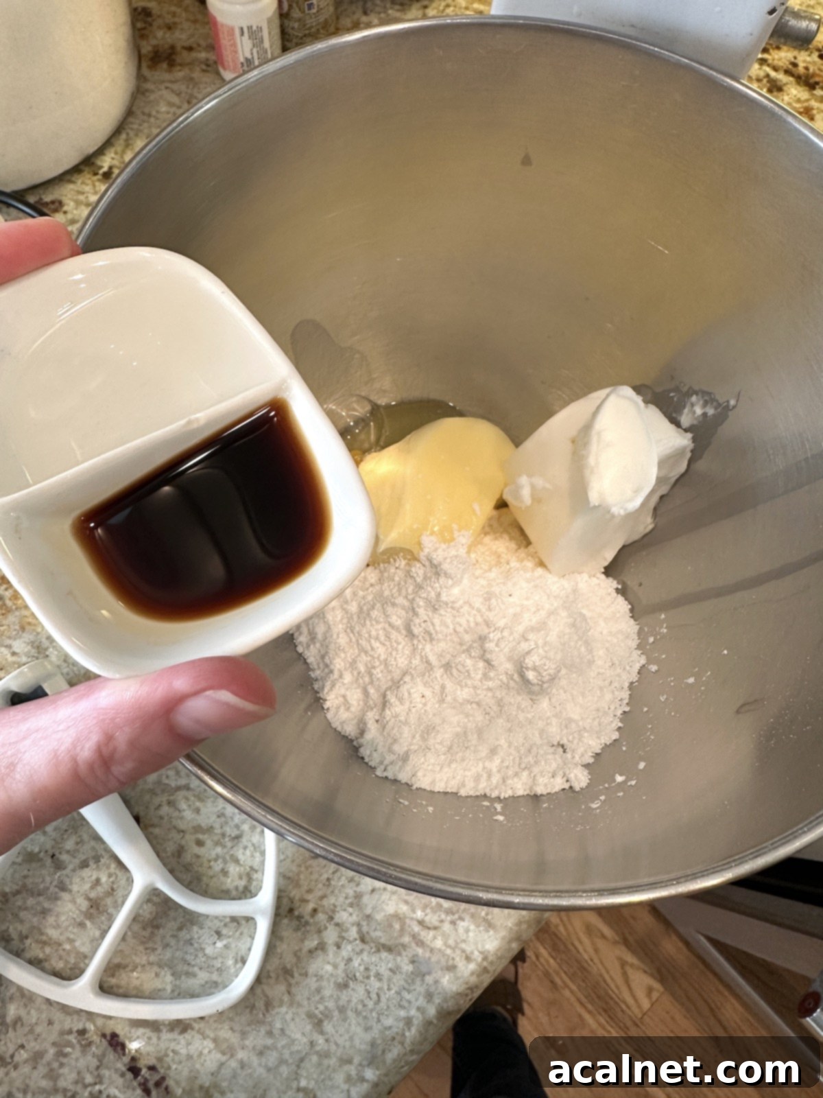 Cookie ingredients are unblended in a mixing bowl.