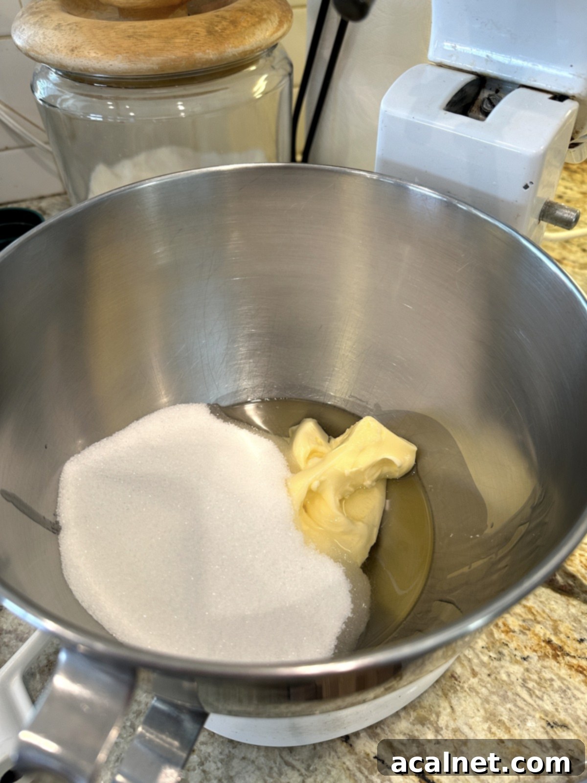 Sugar, vegetable oil, and softened butter in a mixing bowl, ready to be creamed.