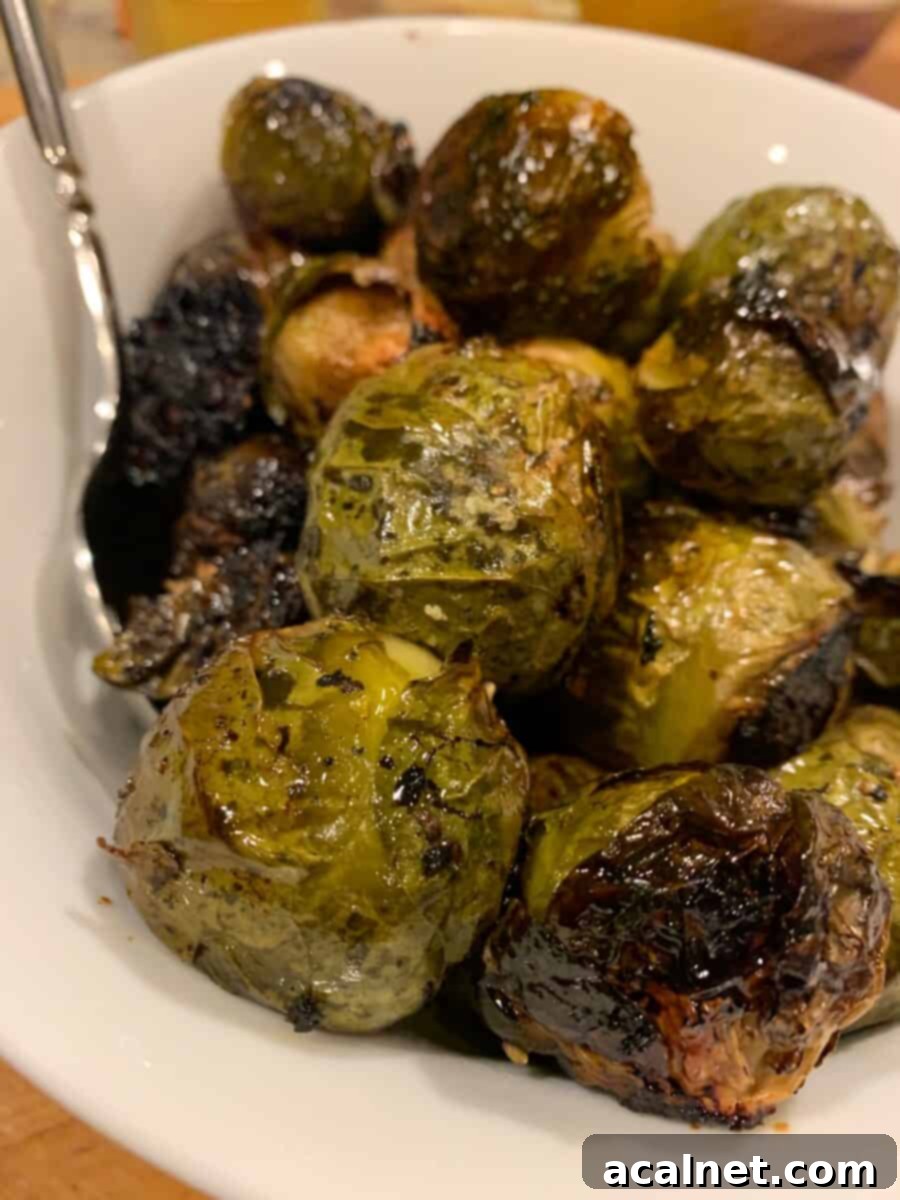 Brussel sprouts on a serving plate with a fork, garnished beautifully