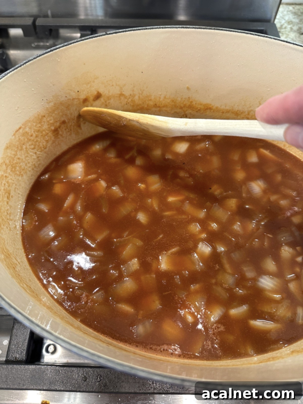 Broth for pot roast with vegetables in a Dutch oven,
