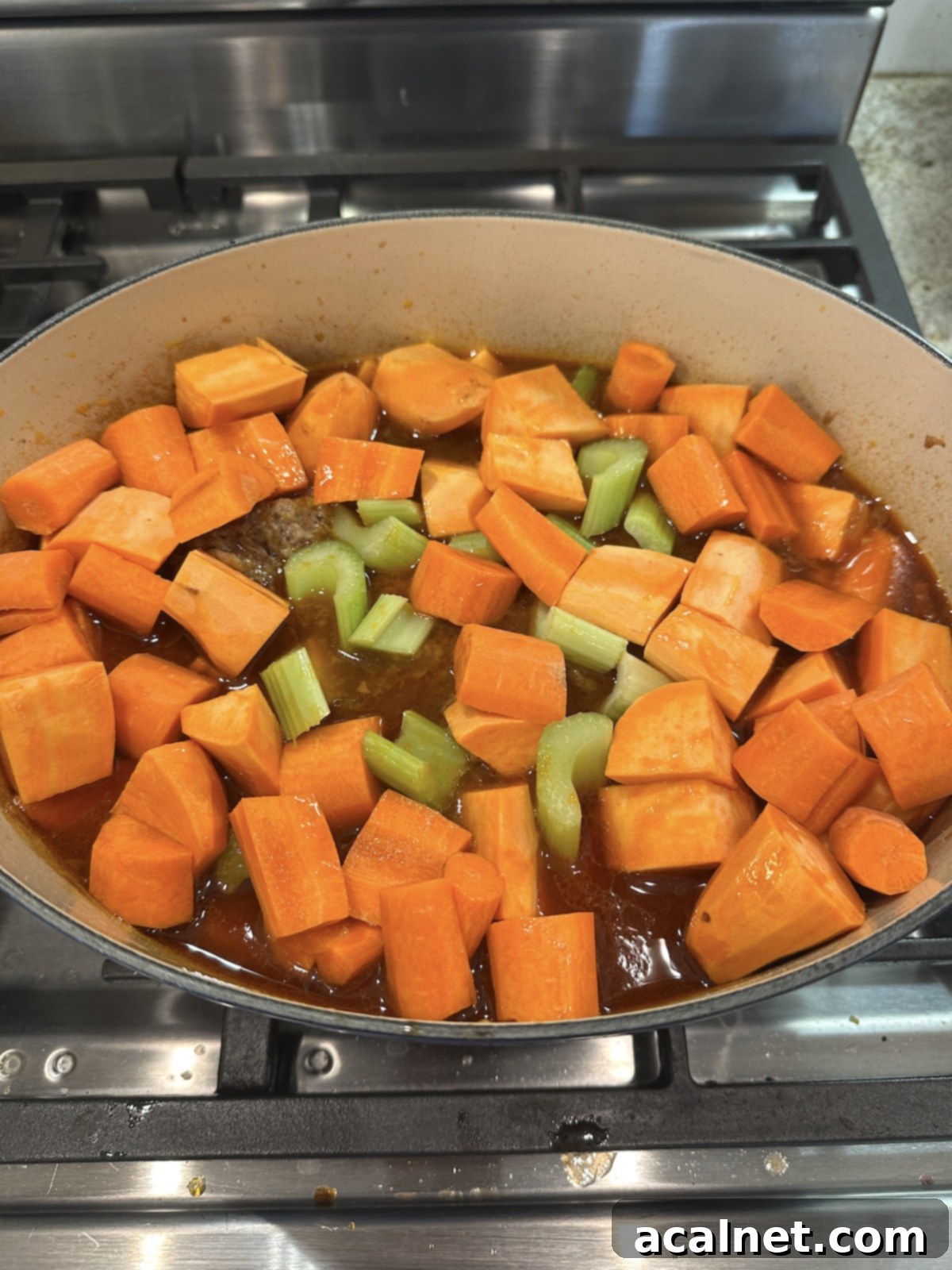 Vegetables in a Dutch oven with pot roast.