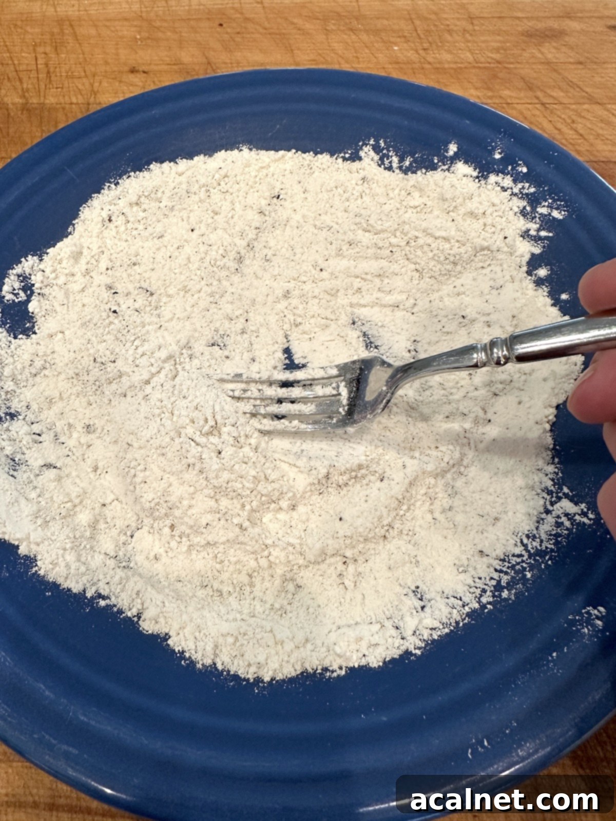 Blended flour, salt and pepper on a plate.