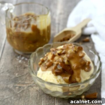 A decadent serving of pecan praline sauce generously drizzled over ice cream.