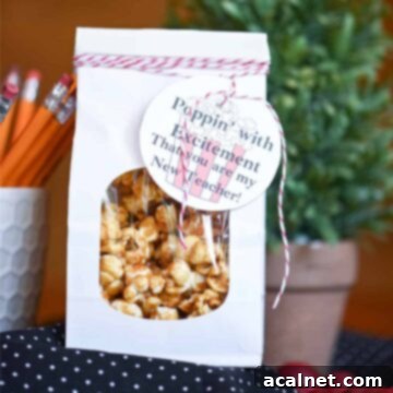 A paper container filled with sweet, crunchy homemade caramel corn.
