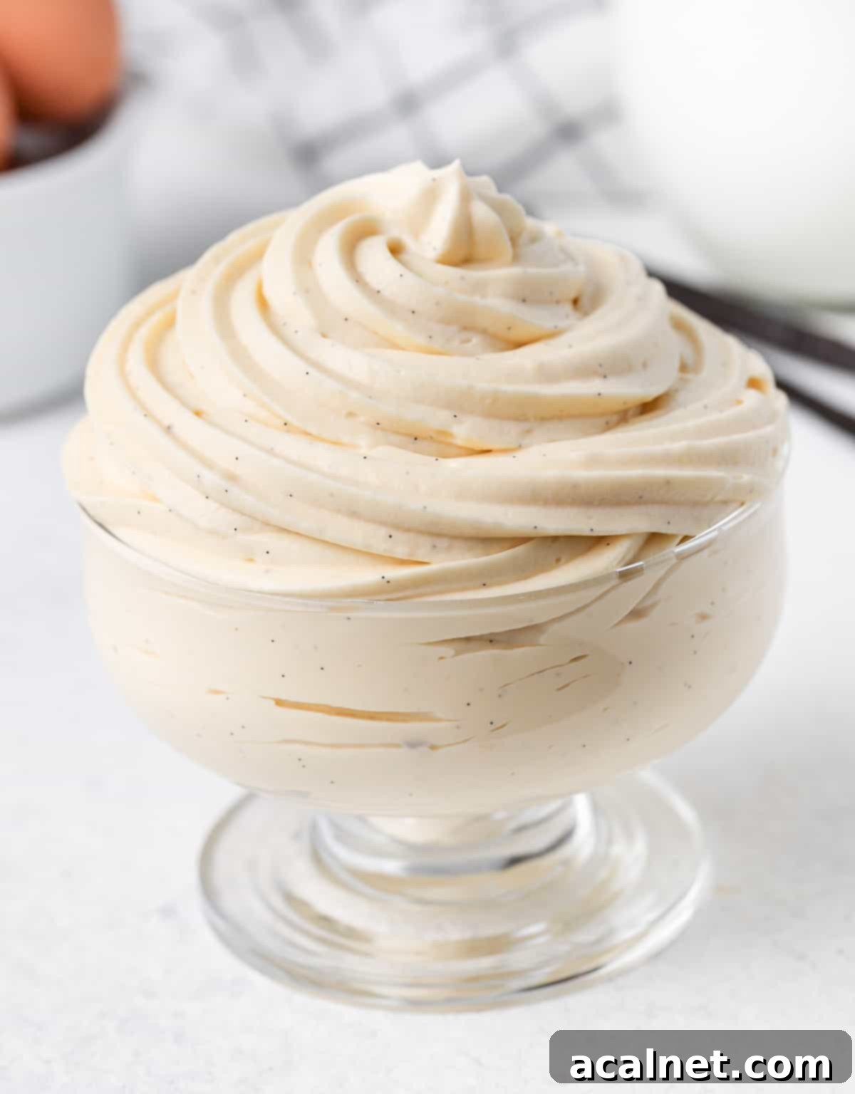 Vanilla Bavarian Cream elegantly piped into a clear glass cup, showcasing its smooth texture and delicate presentation.