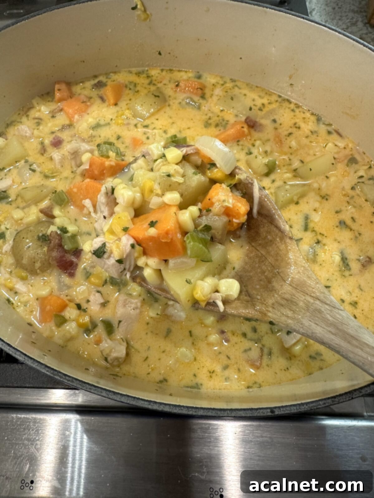 Golden Harvest Chowder 10 A large pot of creamy corn and potato soup, perfectly cooked and ready to be served, showing a rich golden color.