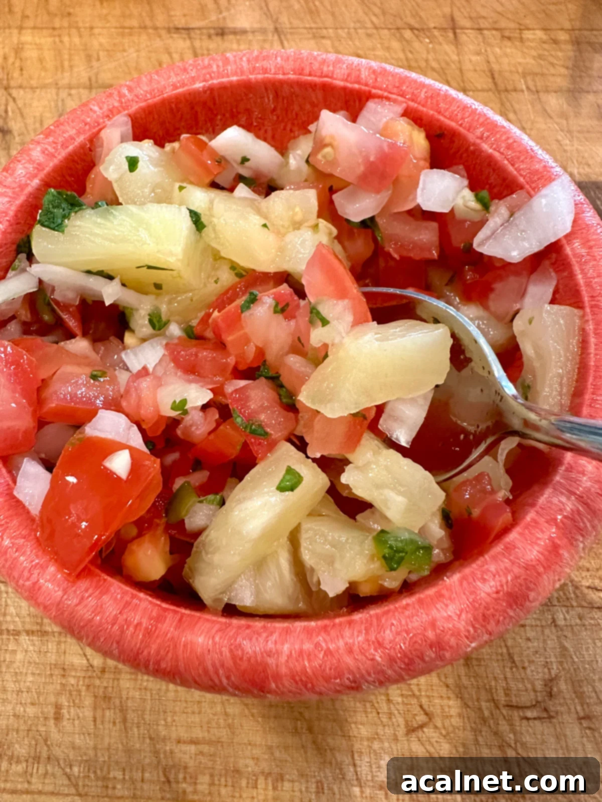 Zesty Jalapeño-Lime Pico de Gallo 7 A colorful bowl of pico de gallo featuring juicy pineapple chunks, creating a sweet and tangy tropical salsa.