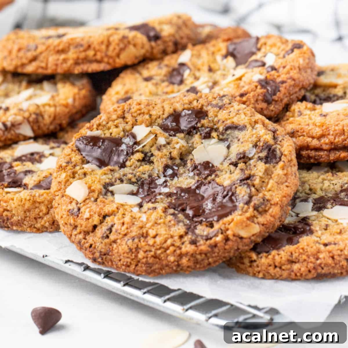 Stack of freshly baked gluten-free chocolate chip almond cookies over a small wire rack, ready to be enjoyed.