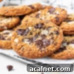 Stack of freshly baked gluten-free chocolate chip almond cookies over a small wire rack.