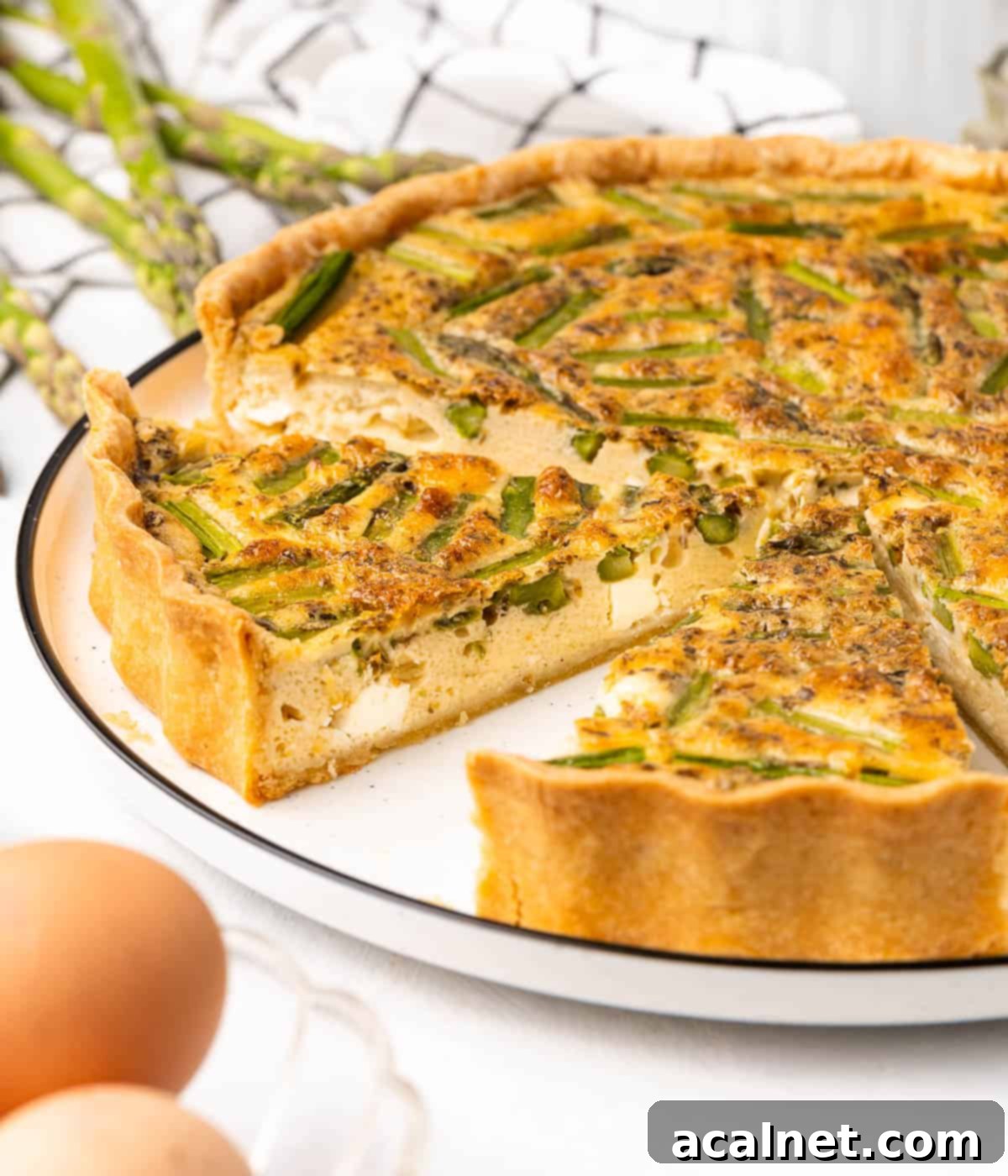 Close up on two cut out slices of quiche over the serving plate.