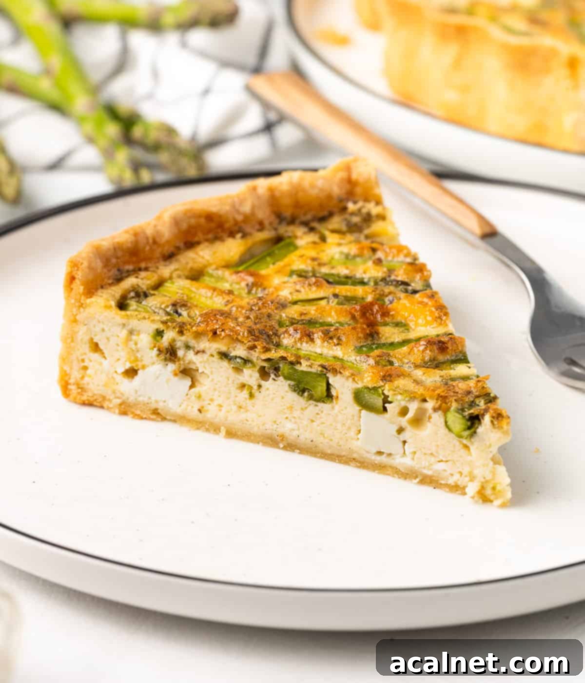 One slice on a small white plate with a fork in the background.