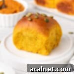 Close up on one pumpkin roll over a small white plate.