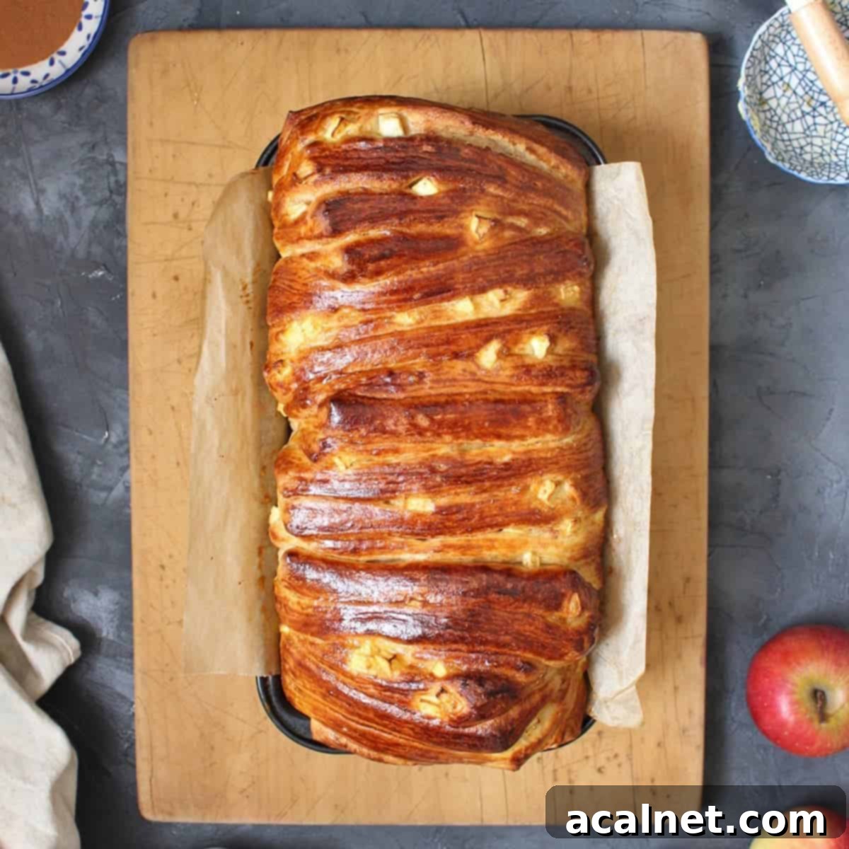 Sweet bread in the baking pan over a wooden board from above