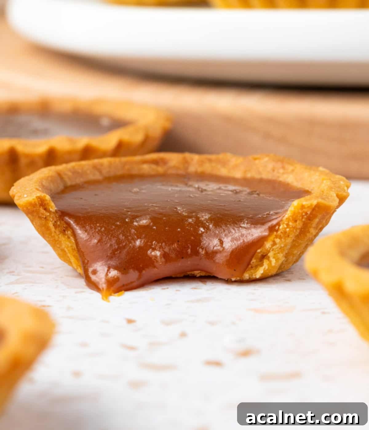 Close up on the caramel filling dripping out of the shell.