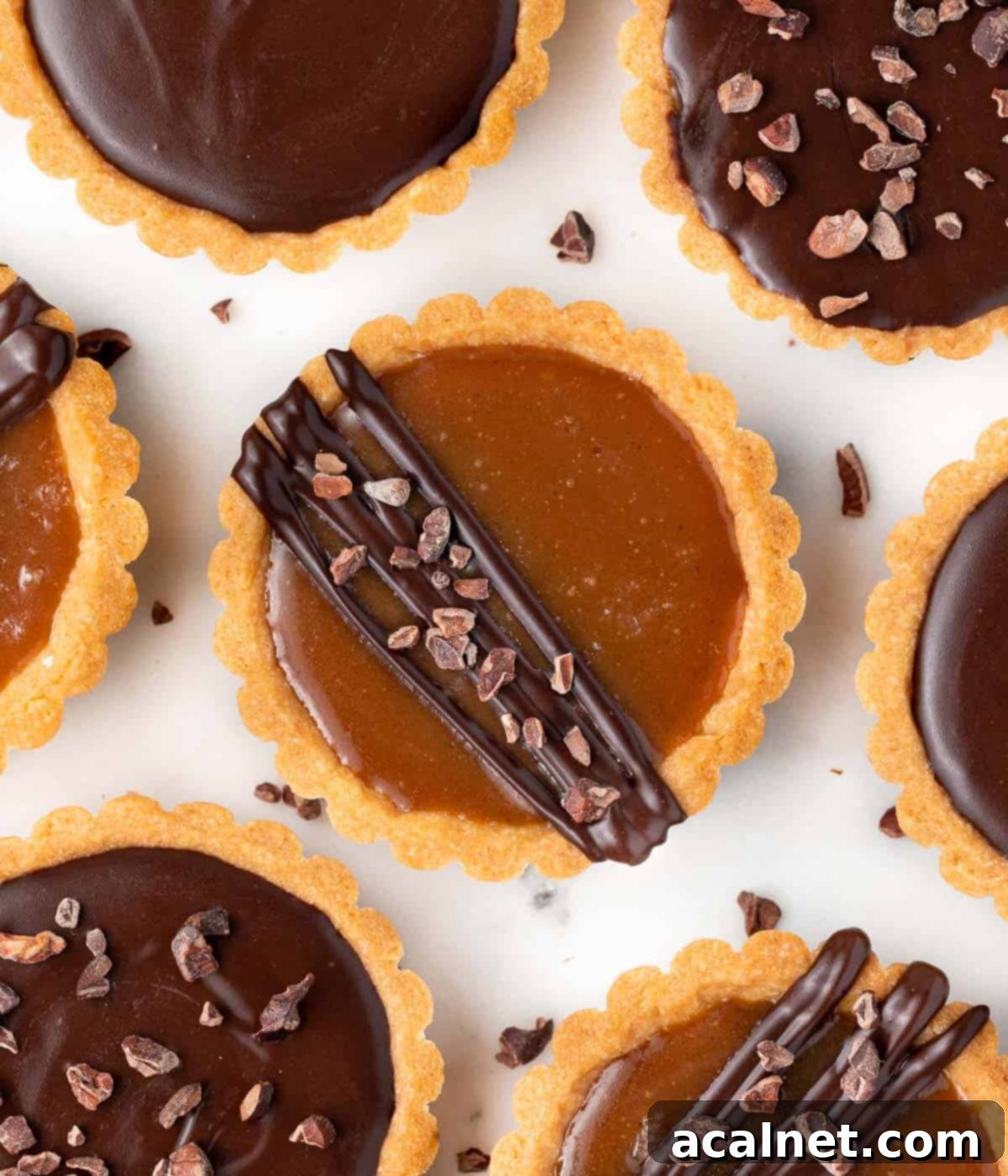 Tartlets seen from above on a white surface.