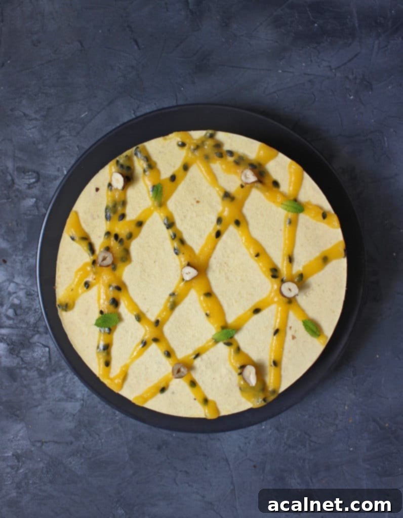 Vegan No-Bake Mango Cheesecake 3 Cake from above on a black plate over a dark grey surface, highlighting the smooth texture